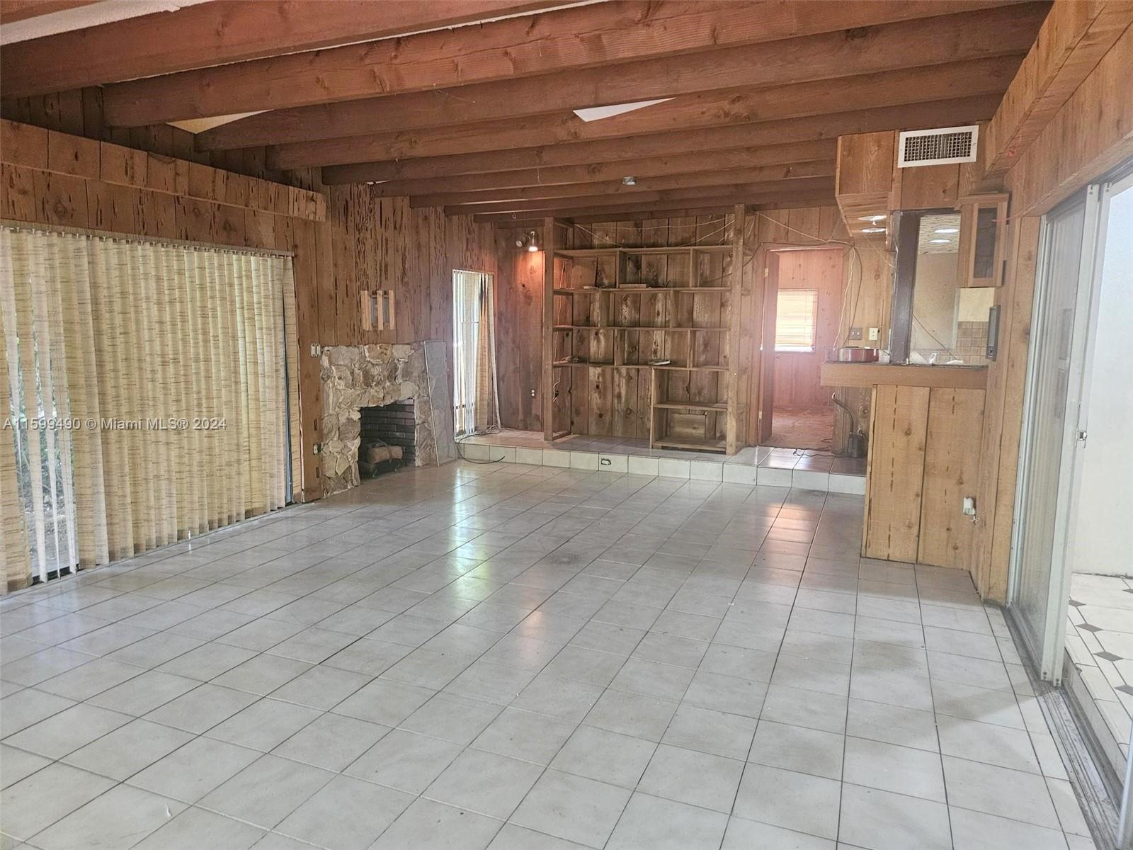 10470 Southwest 93rd Street Miami, FL 33176 - Photo 8 of 14 a view of an empty room with a fireplace