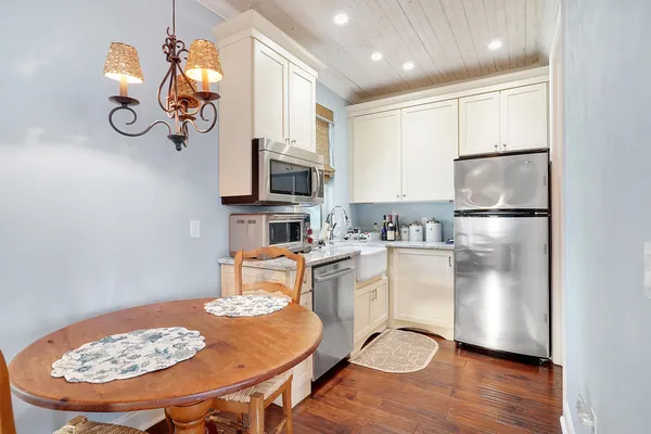 a view of a room with wooden floor and ceiling fan