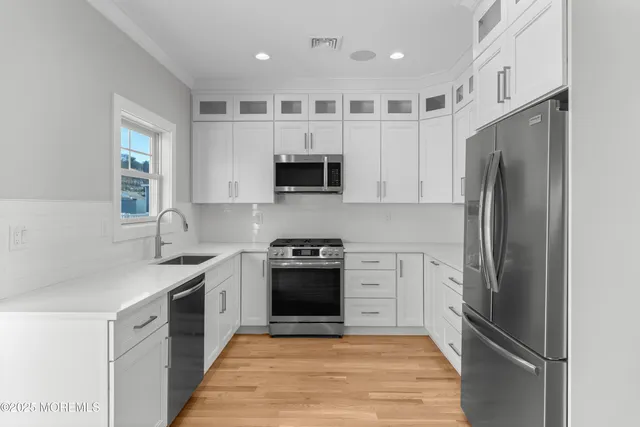a kitchen with a refrigerator stove and microwave
