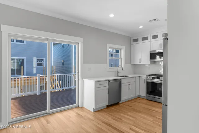 a kitchen with stainless steel appliances granite countertop a stove and a sink