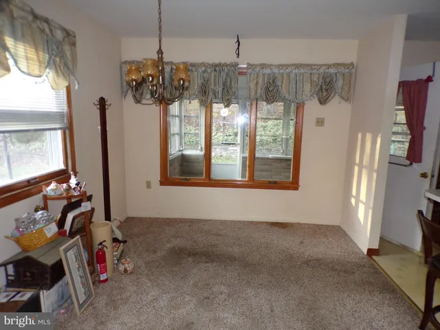 a view of a room with window and refrigerator