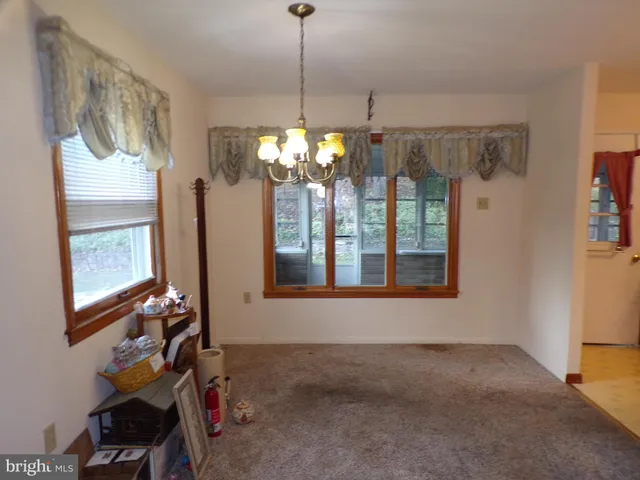 a view of a room with a window and chandelier