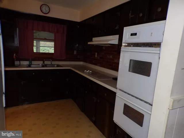 a kitchen with a sink and white cabinets