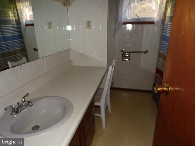 a bathroom with a sink and mirror