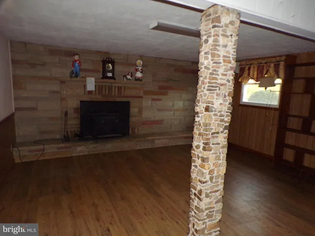 a room with wooden floor and a fireplace