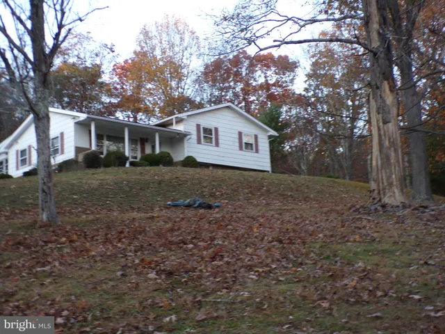 a house is sitting in middle of the forest