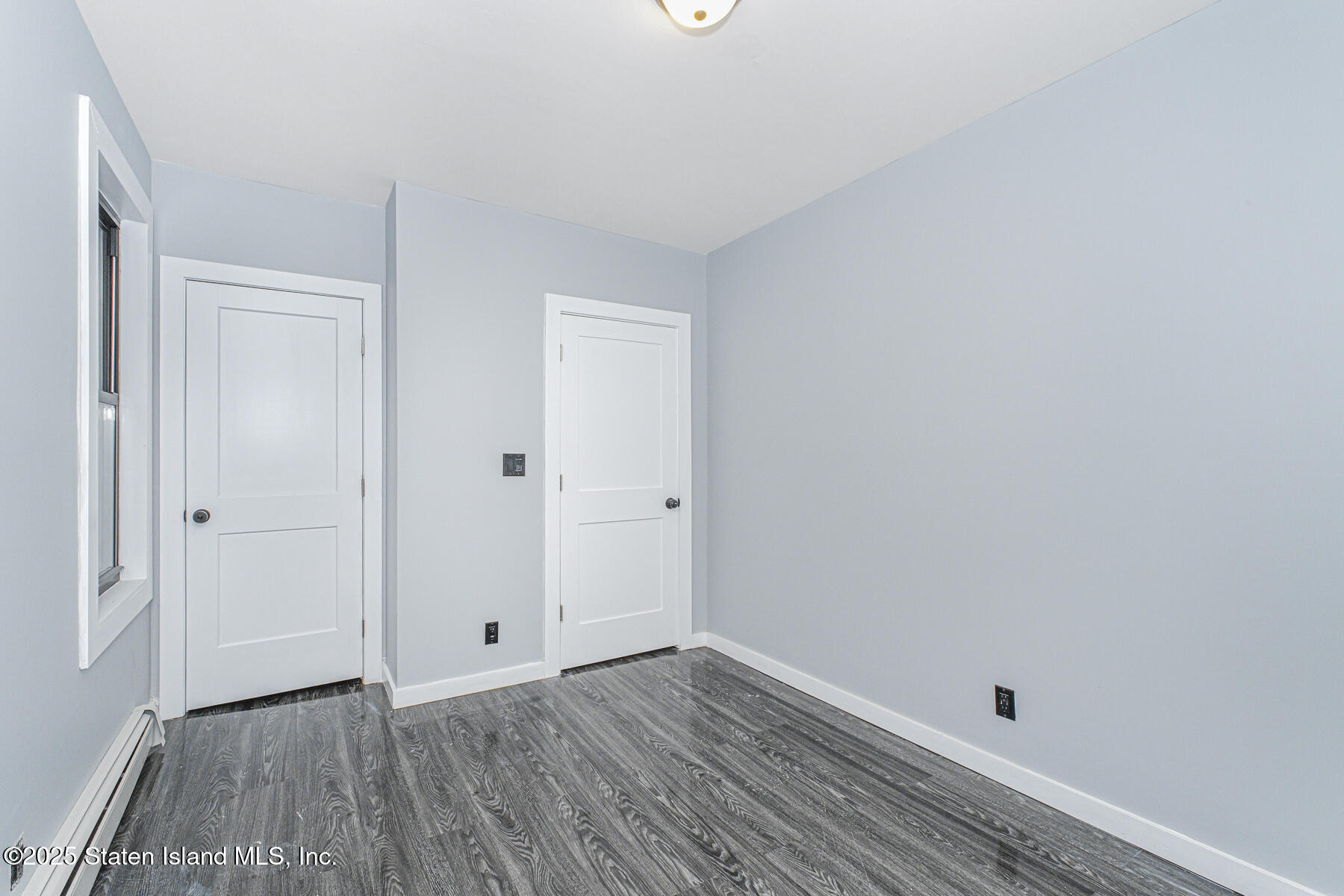 71 Sands Street Staten Island, NY 10304 - Photo 14 of 35 a view of a room with wooden floor and white walls