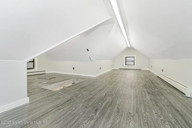 a view of a room with wooden floor and white walls