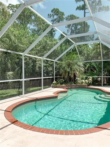 a view of a backyard with swimming pool