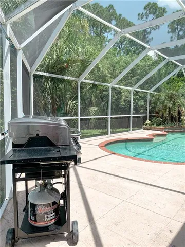 a backyard of a house with basket ball table and chairs