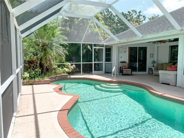 a view of a house with backyard sitting area and porch