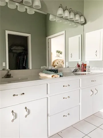 a bathroom with a sink vanity and mirror