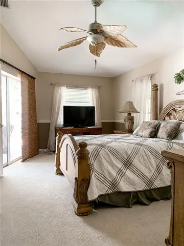 a bedroom with a bed and ceiling fan