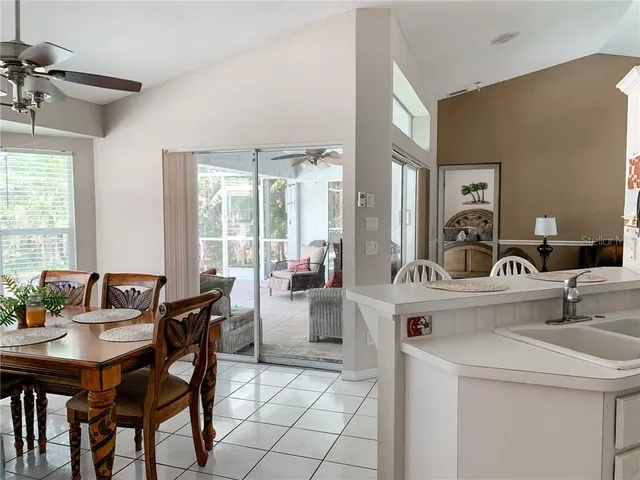 a view of a dining room with furniture and a large window