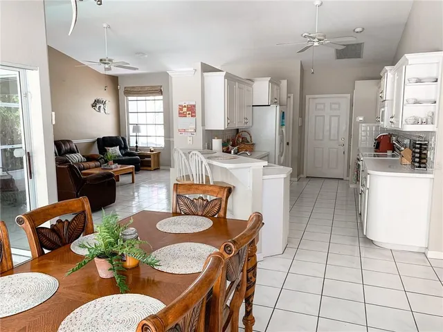 a living room with furniture a dining table and chairs
