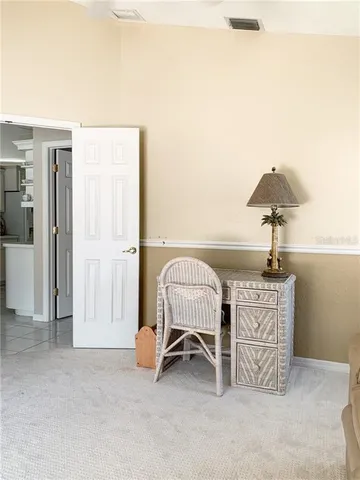 a room with a table chair and a chandelier