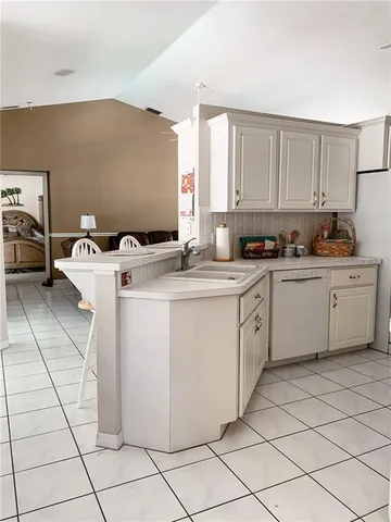 a utility room with cabinets washer and dryer