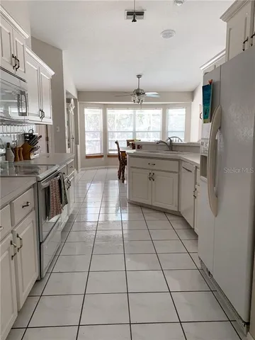 a kitchen with stainless steel appliances a stove sink and cabinets