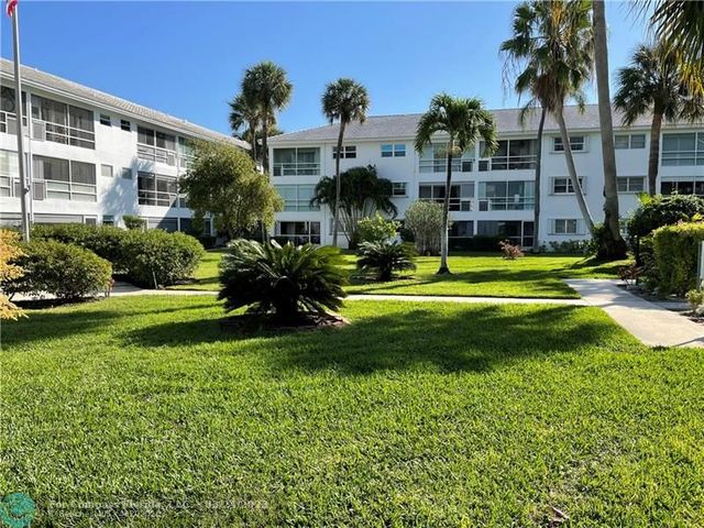 a view of a house with a swimming pool and a garden
