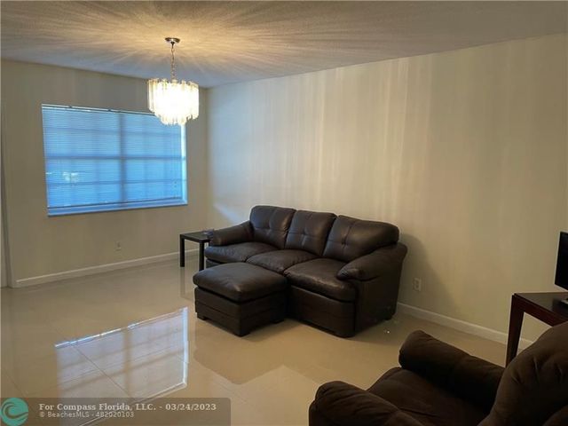 a living room with furniture and a lamp