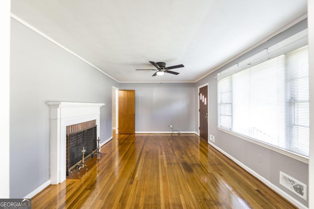 103 Thomas Street Dublin, GA 31021 - Photo 11 of 24 a view of empty room with wooden floor and fan