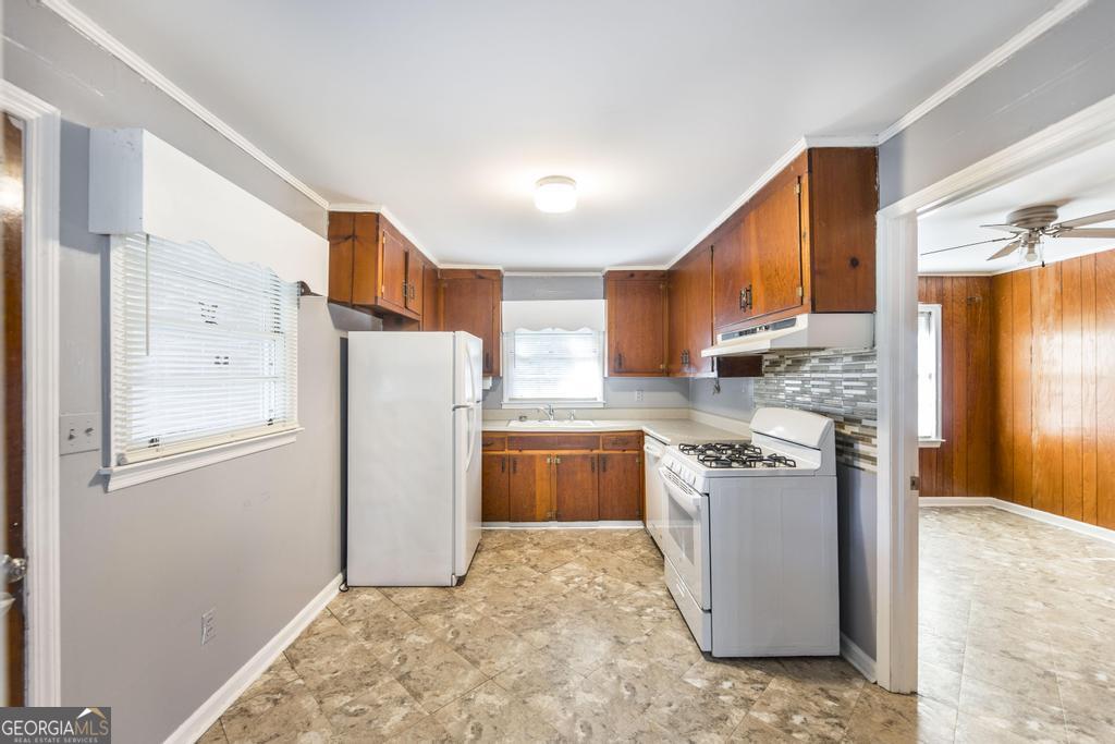 103 Thomas Street Dublin, GA 31021 - Photo 13 of 24 a kitchen with refrigerator and cabinets