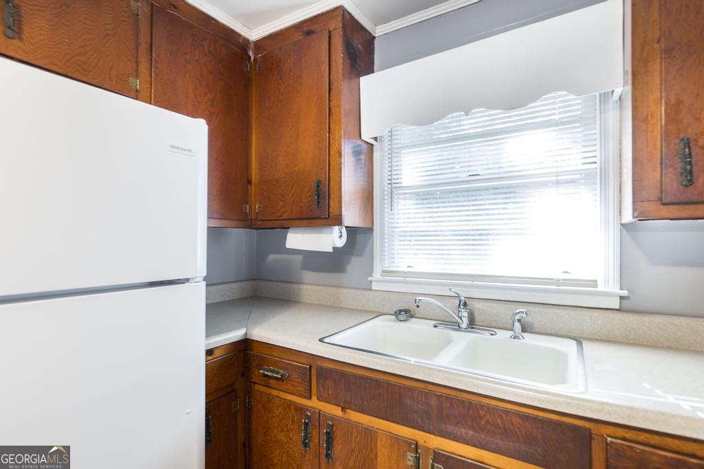 103 Thomas Street Dublin, GA 31021 - Photo 16 of 24 a kitchen with a sink cabinets and window