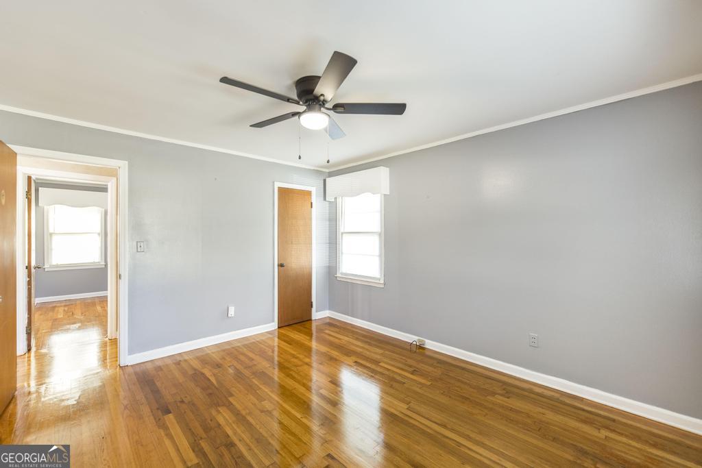 103 Thomas Street Dublin, GA 31021 - Photo 21 of 24 a view of empty room with wooden floor and fan