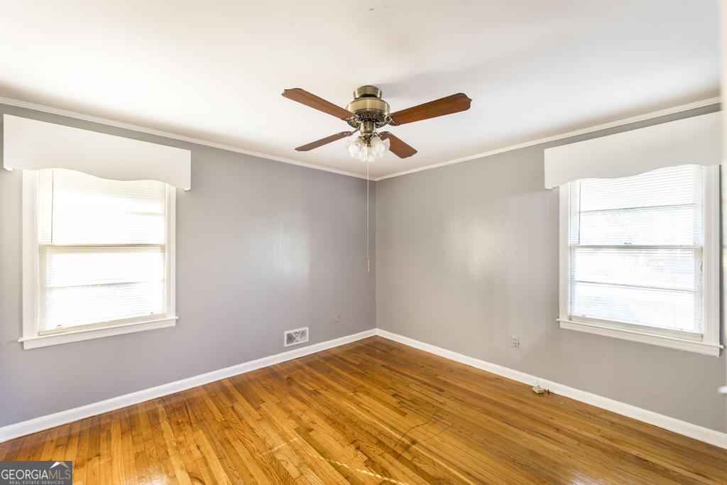 103 Thomas Street Dublin, GA 31021 - Photo 22 of 24 a view of a room with a window and a ceiling fan