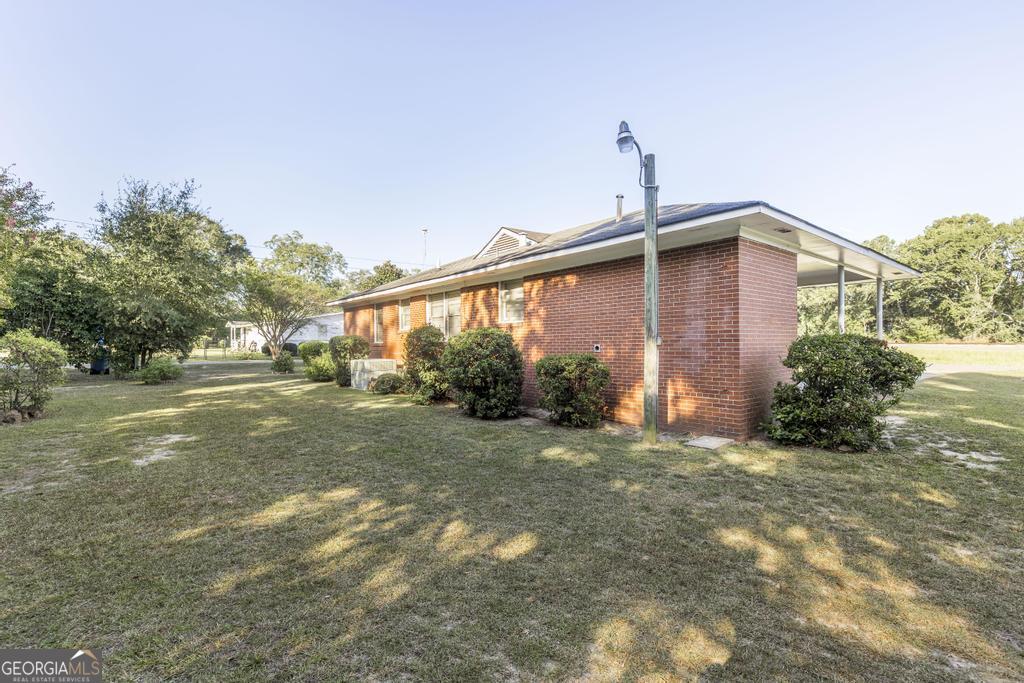 103 Thomas Street Dublin, GA 31021 - Photo 8 of 24 a front view of a house with a yard