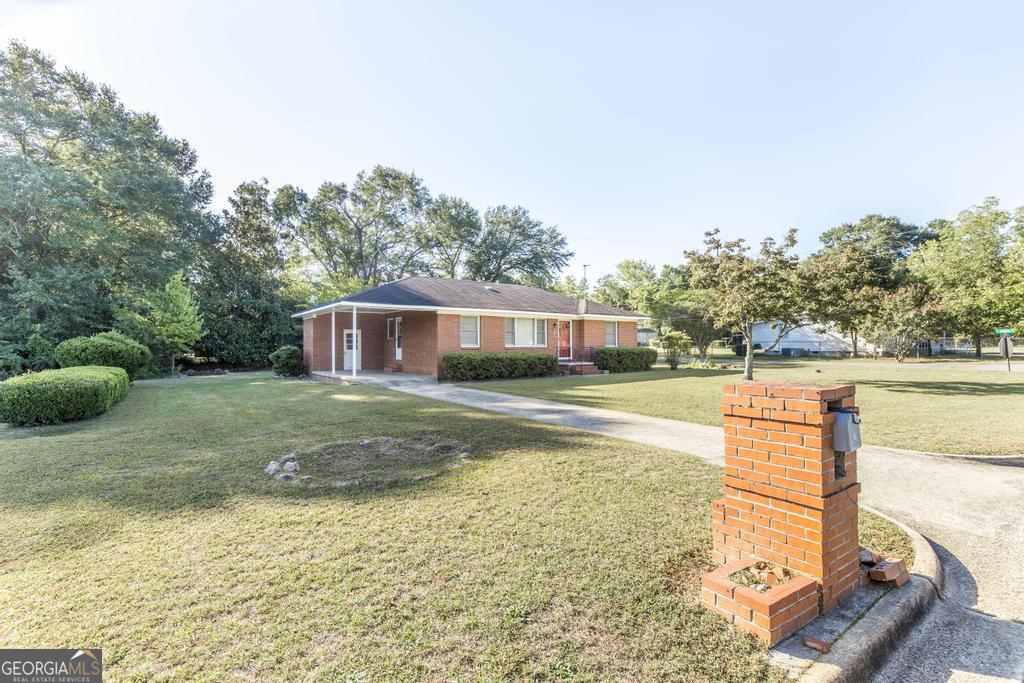 103 Thomas Street Dublin, GA 31021 - Photo 10 of 24 a view of a house with a yard and sitting area