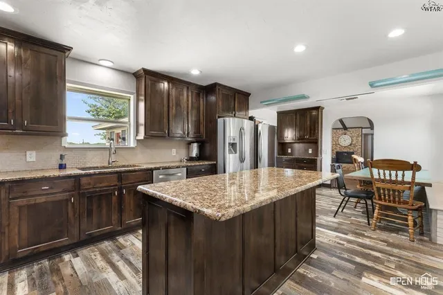 an empty room with window and wooden floor