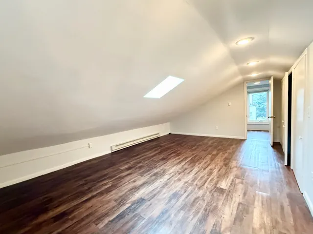 a view of an empty room and wooden floor