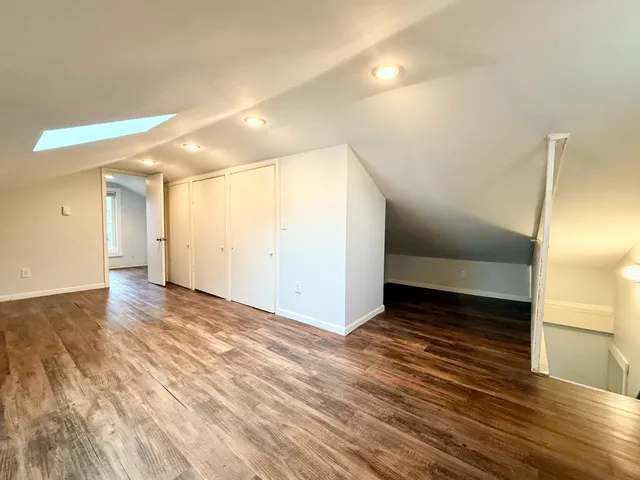 a view of an empty room and wooden floor
