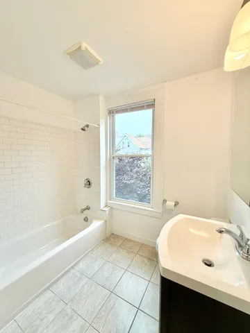 a bathroom with a bathtub and a sink