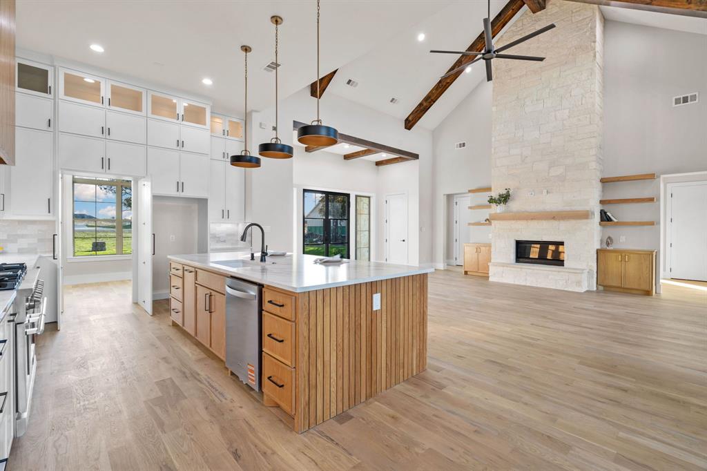 559 Aermotor Loop Weatherford, TX 76085 - Photo 12 of 39 a kitchen with stainless steel appliances granite countertop a lot of cabinets and wooden floor