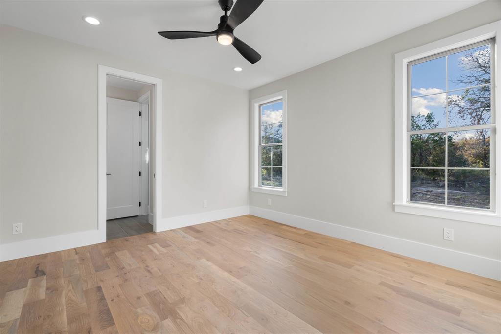 559 Aermotor Loop Weatherford, TX 76085 - Photo 20 of 39 wooden floor in an empty room with a window