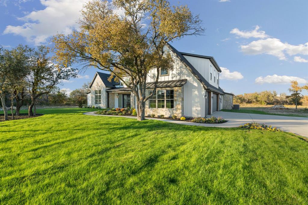 559 Aermotor Loop Weatherford, TX 76085 - Photo 2 of 39 a backyard of a house with table and chairs