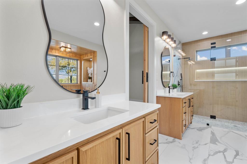 559 Aermotor Loop Weatherford, TX 76085 - Photo 29 of 39 a bathroom with a sink a mirror and a shower