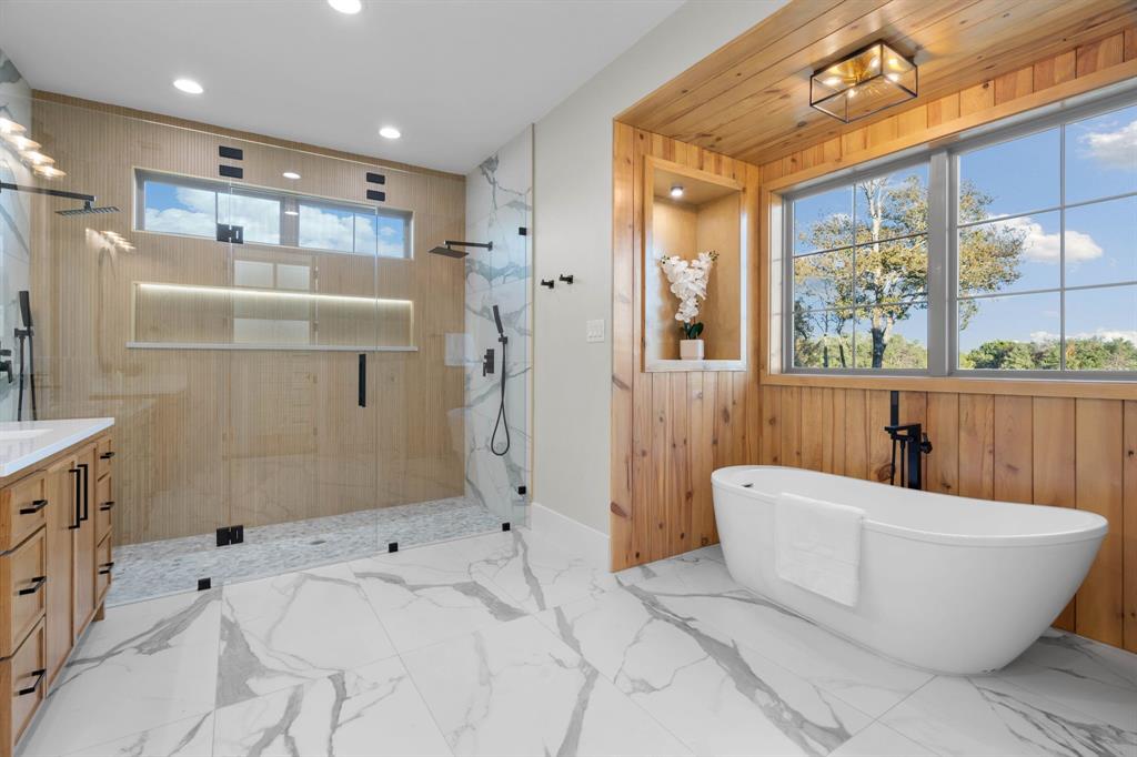 559 Aermotor Loop Weatherford, TX 76085 - Photo 30 of 39 a bathroom with a bathtub and shower