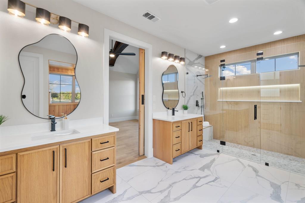 559 Aermotor Loop Weatherford, TX 76085 - Photo 31 of 39 a bathroom with a double vanity sink mirror and shower