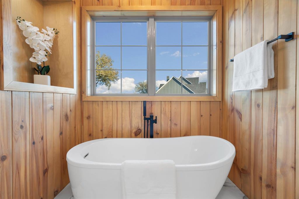 559 Aermotor Loop Weatherford, TX 76085 - Photo 32 of 39 a white tub sitting in a bathroom next to a window