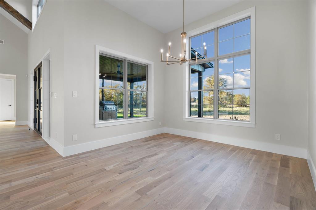 559 Aermotor Loop Weatherford, TX 76085 - Photo 10 of 39 a view of an empty room with wooden floor and a window