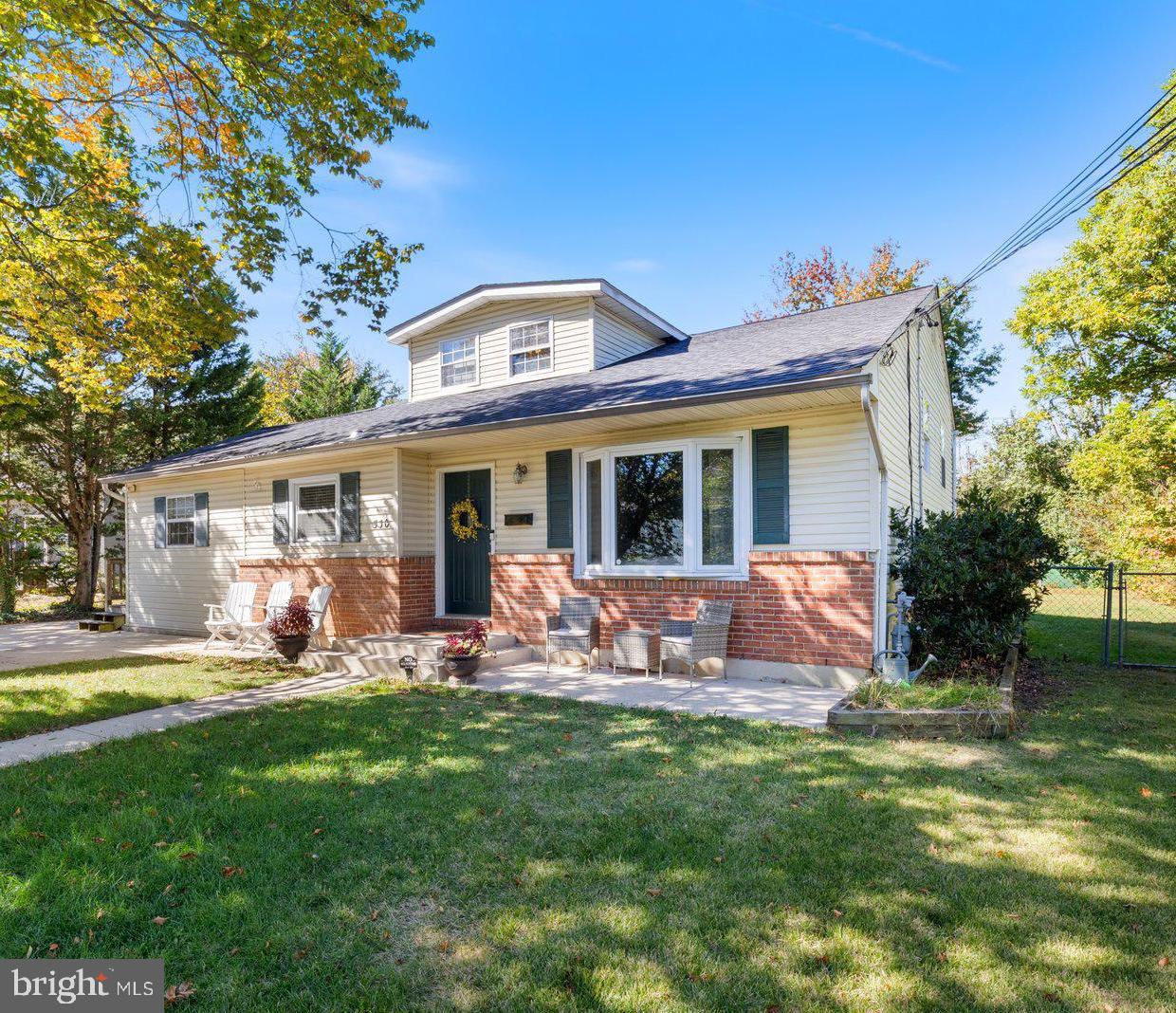 a front view of house with outdoor seating and yard