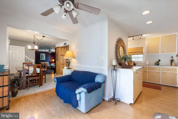 a living room with furniture and kitchen view