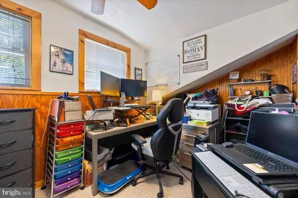 a view of a workspace with furniture and a window