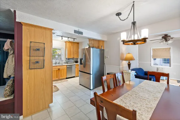 a kitchen with stainless steel appliances granite countertop a refrigerator a stove and a sink