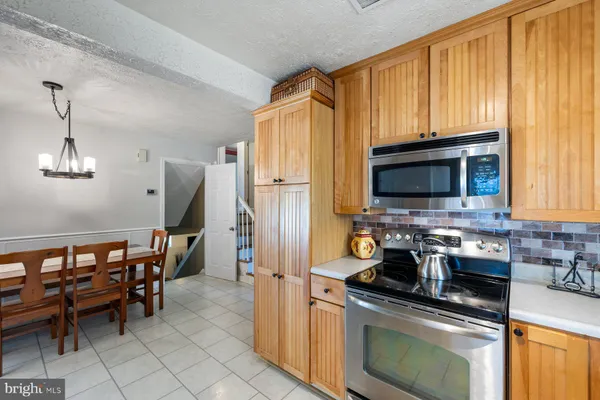 a kitchen with stainless steel appliances a stove a sink and a microwave