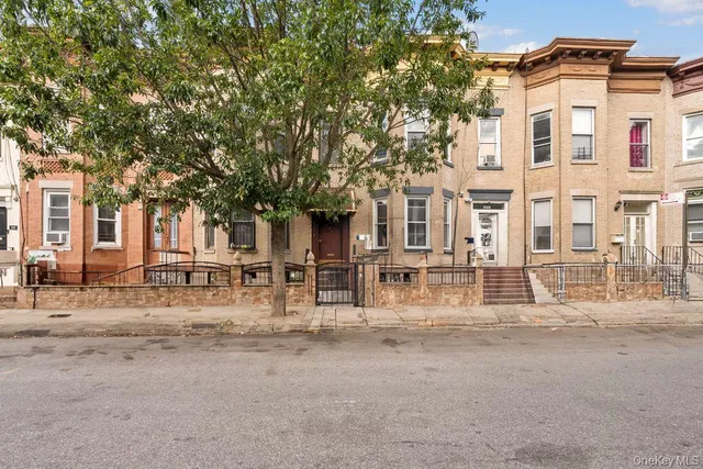 a view of a building with large trees and outdoor space