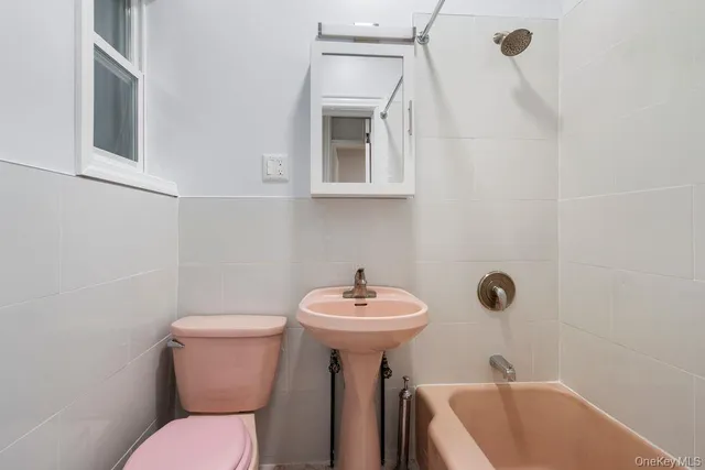 a bathroom with a sink mirror and toilet